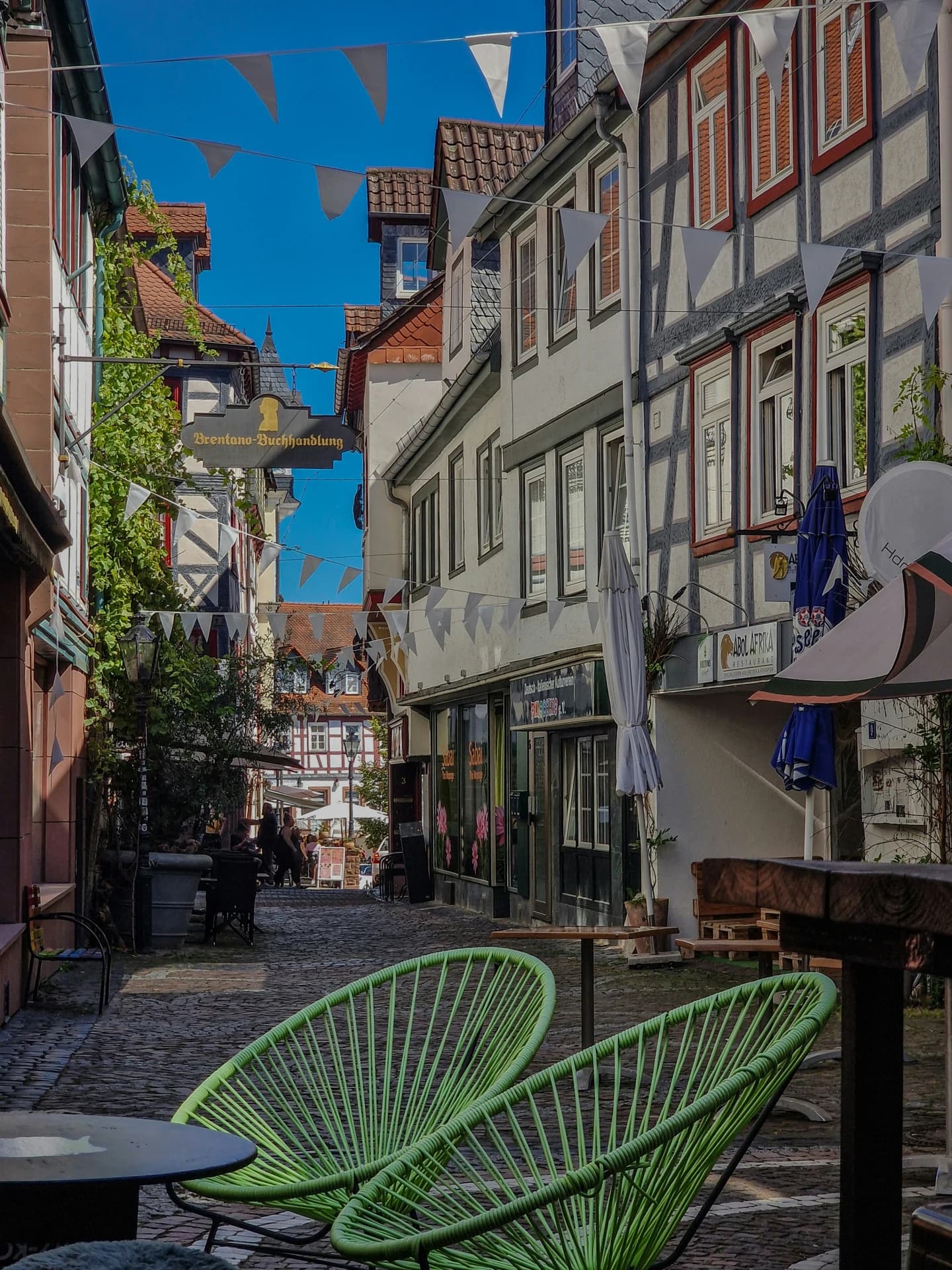 Gasse mit Außengastronomie und Fachwerkhäusern in der Altstadt von Gelnhausen