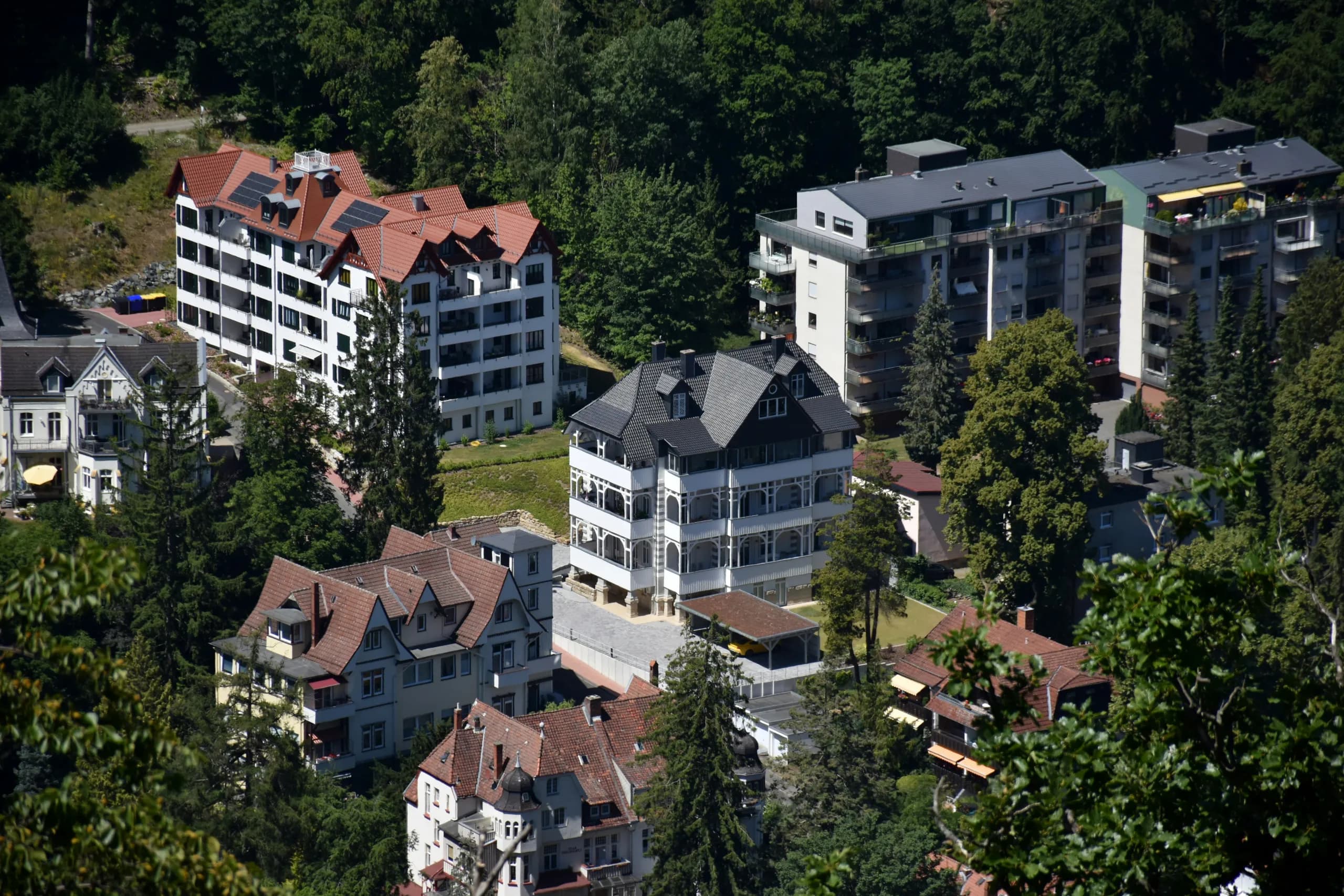 Villen und Mehrfamilienhäuser am bewaldeten Hang