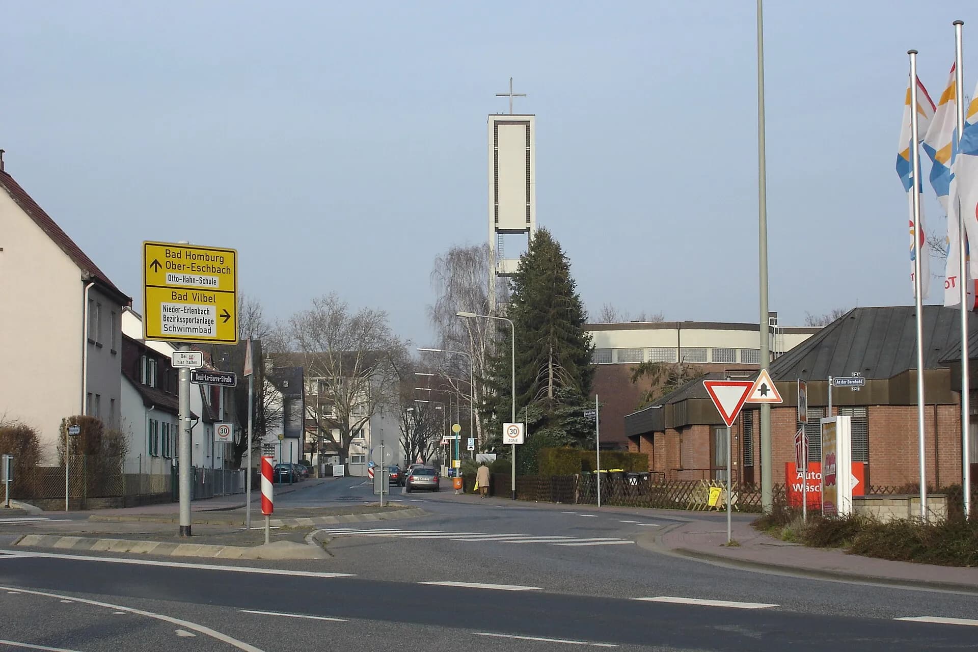 Straßenansicht mit dem Glockenturm von St. Stephanus in Frankfurt Nieder-Eschbach